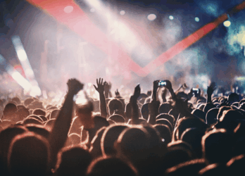 Crowd enjoying a vibrant Dermot Kennedy Dublin concert with colorful stage lights and energetic atmosphere.