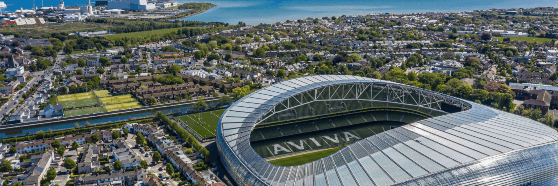 Aerial view of Aviva Stadium in Dublin, venue for the Dermot Kennedy Dublin concert, surrounded by cityscape and coastline.