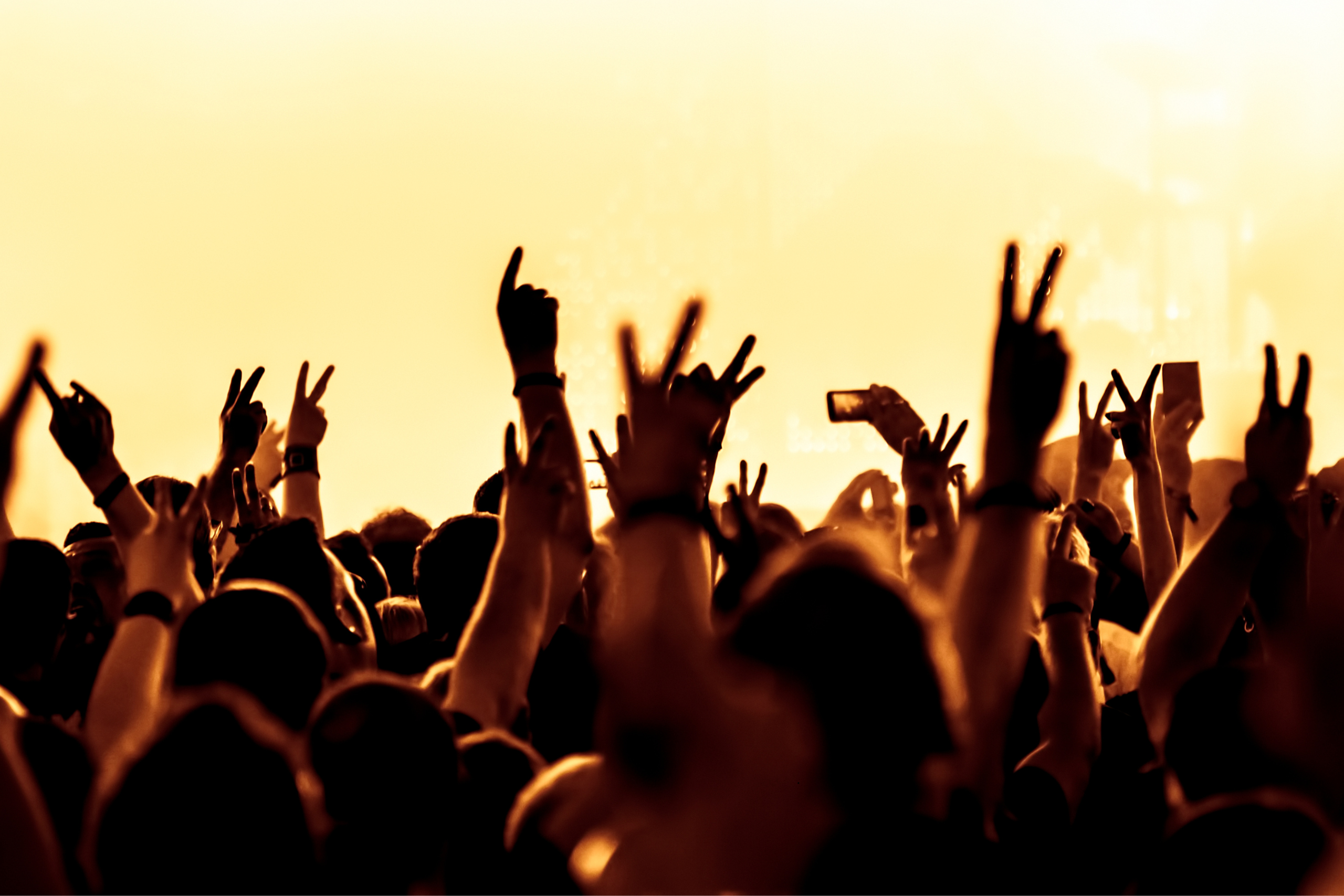 Excited crowd raising hands at The Weeknd concert in Dublin, vibrant atmosphere near Croke Park with fans enjoying live music, close to The Grafton Hotel.
