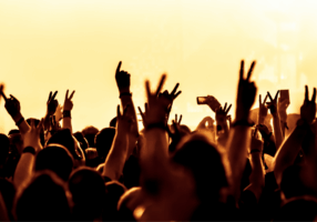 Excited crowd raising hands at The Weeknd concert in Dublin, vibrant atmosphere near Croke Park with fans enjoying live music, close to The Grafton Hotel.